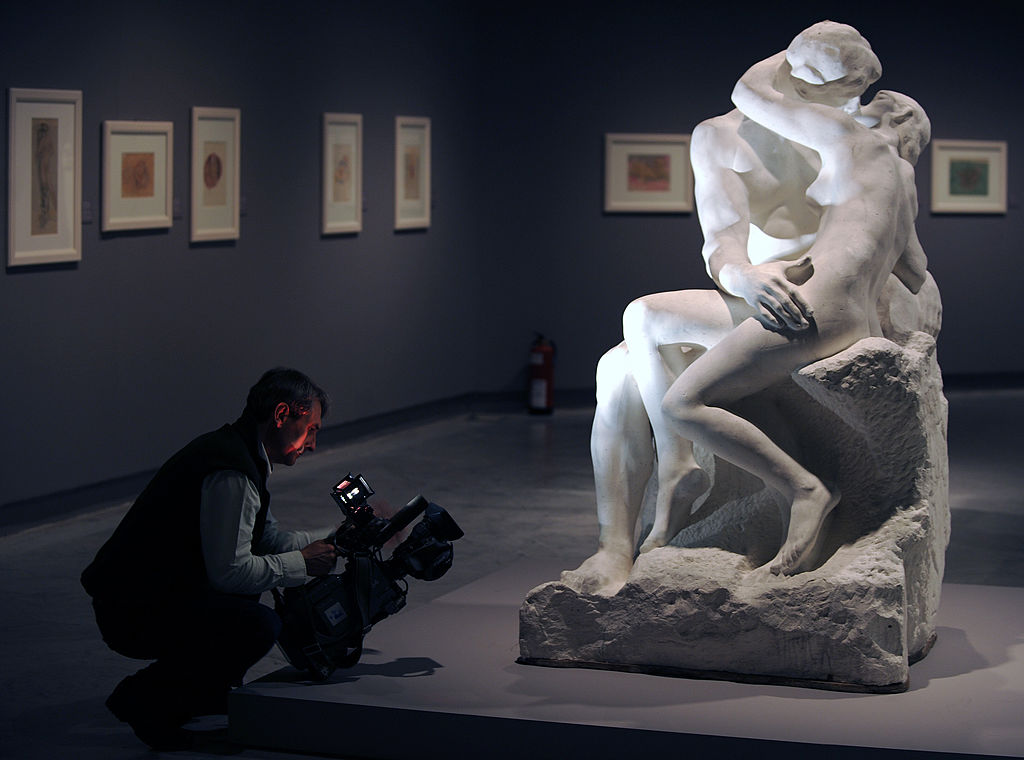 A cameraman films "The kiss" sculpture by French artist Auguste Rodin