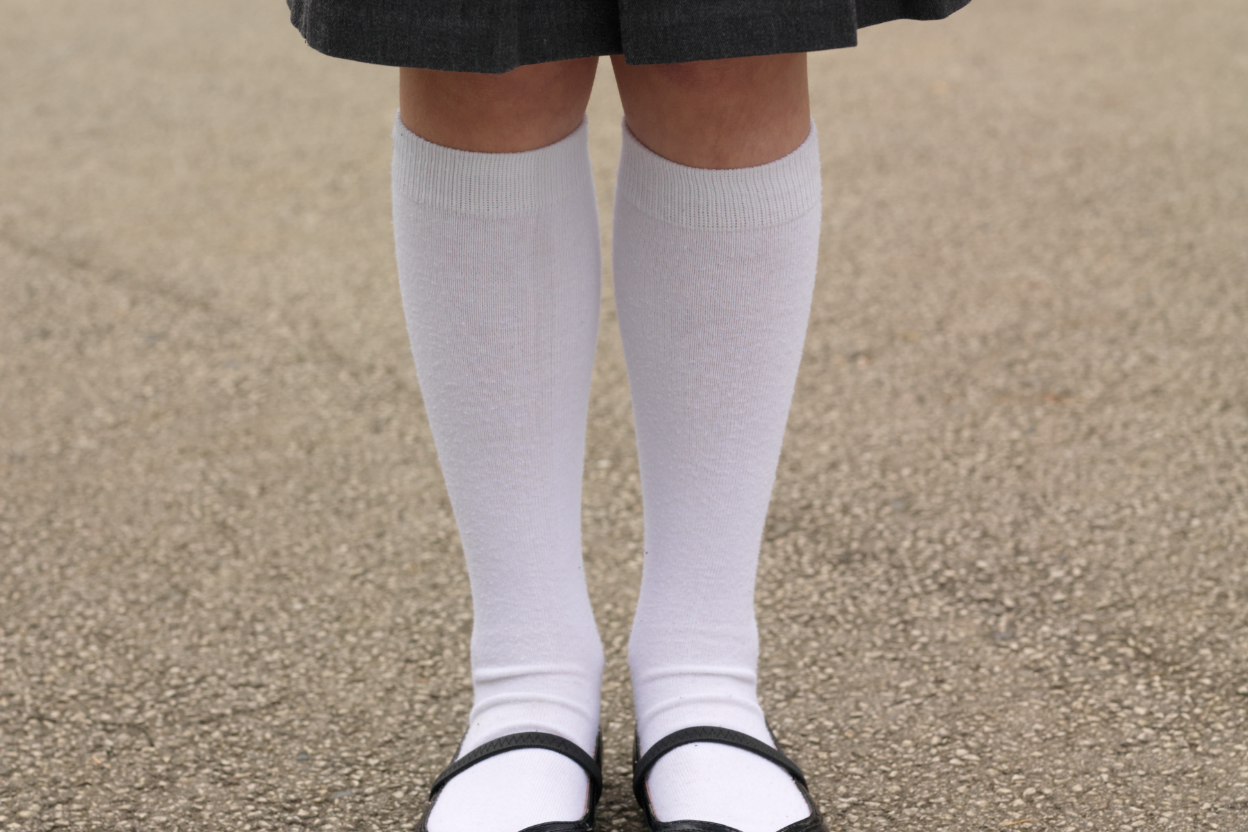 A school girl with knee-high white socks