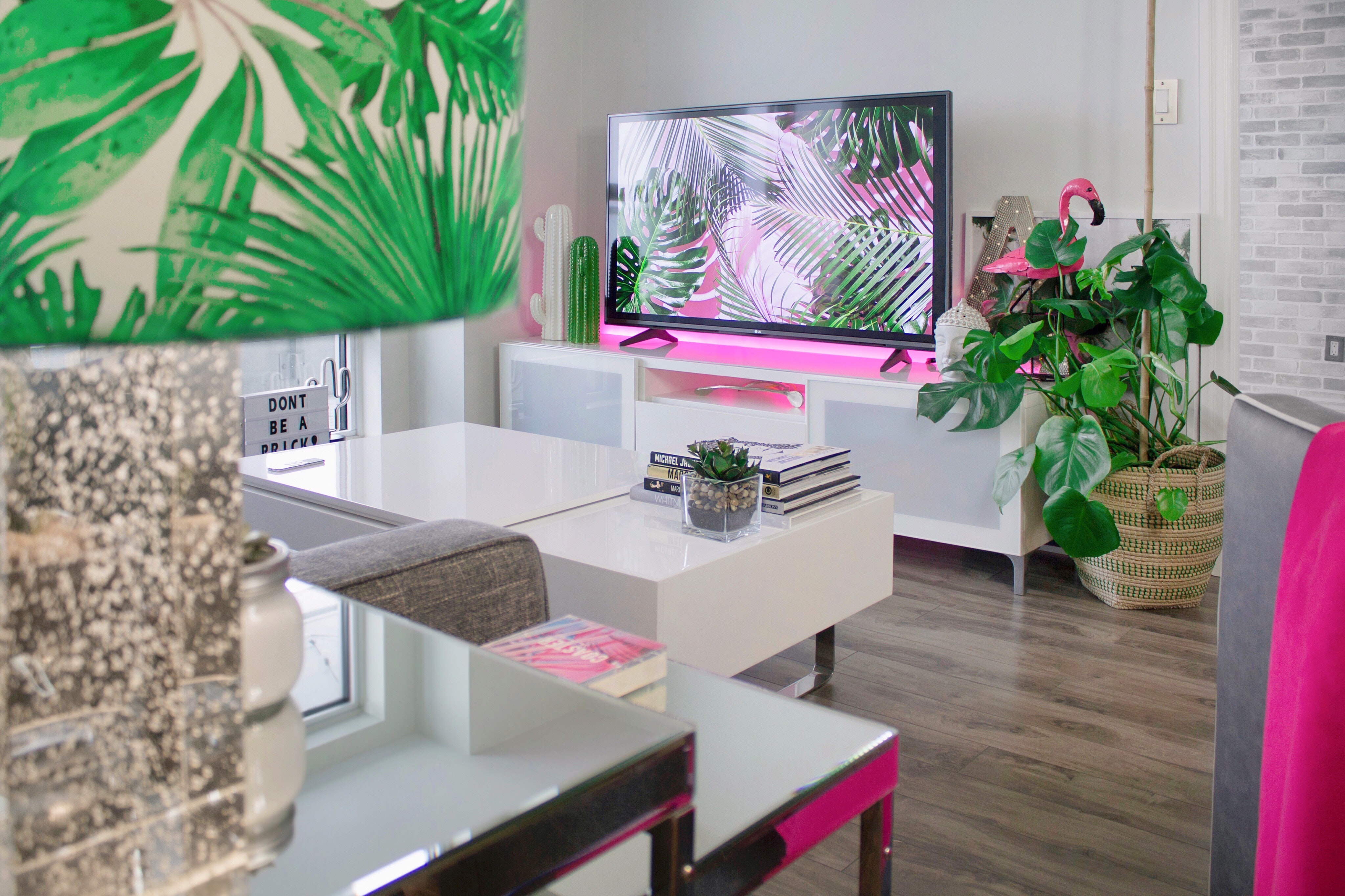 A smart television set in a pink-themed living room