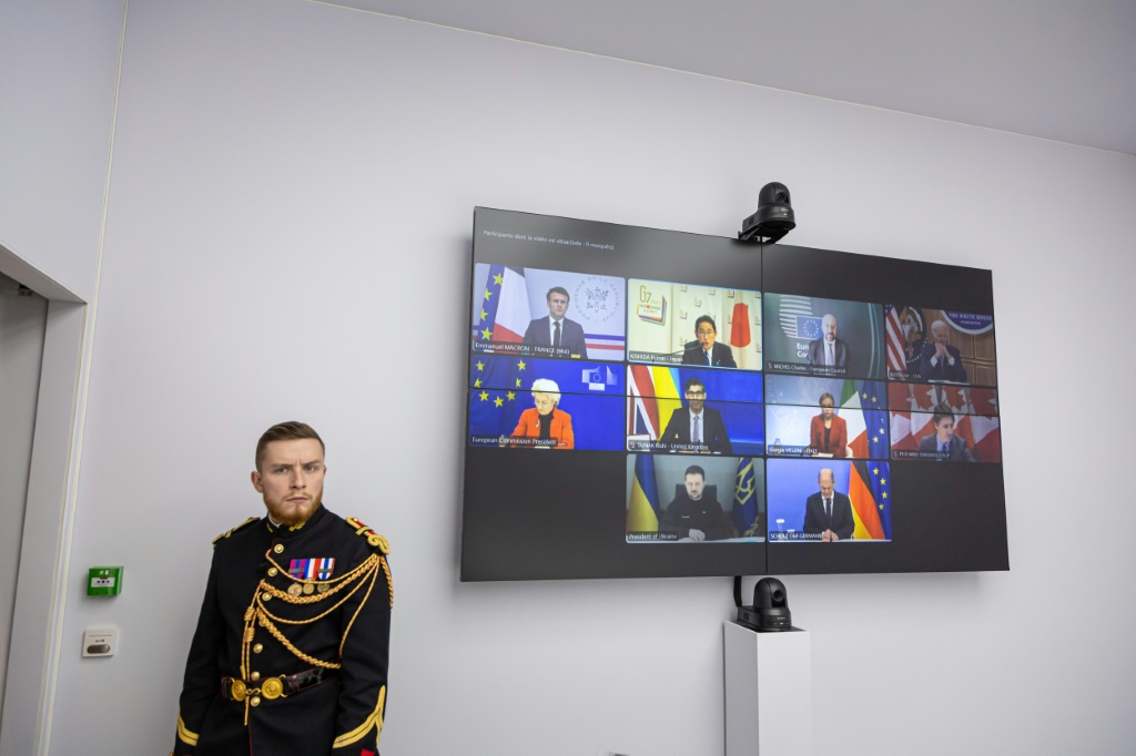 The United States rolled out new sanctions against Russia over its invasion of Ukraine in concert with G7 parnters -- the G7 leaders held a virtual meeting (seen on screen) to mark the anniversary of the invasion