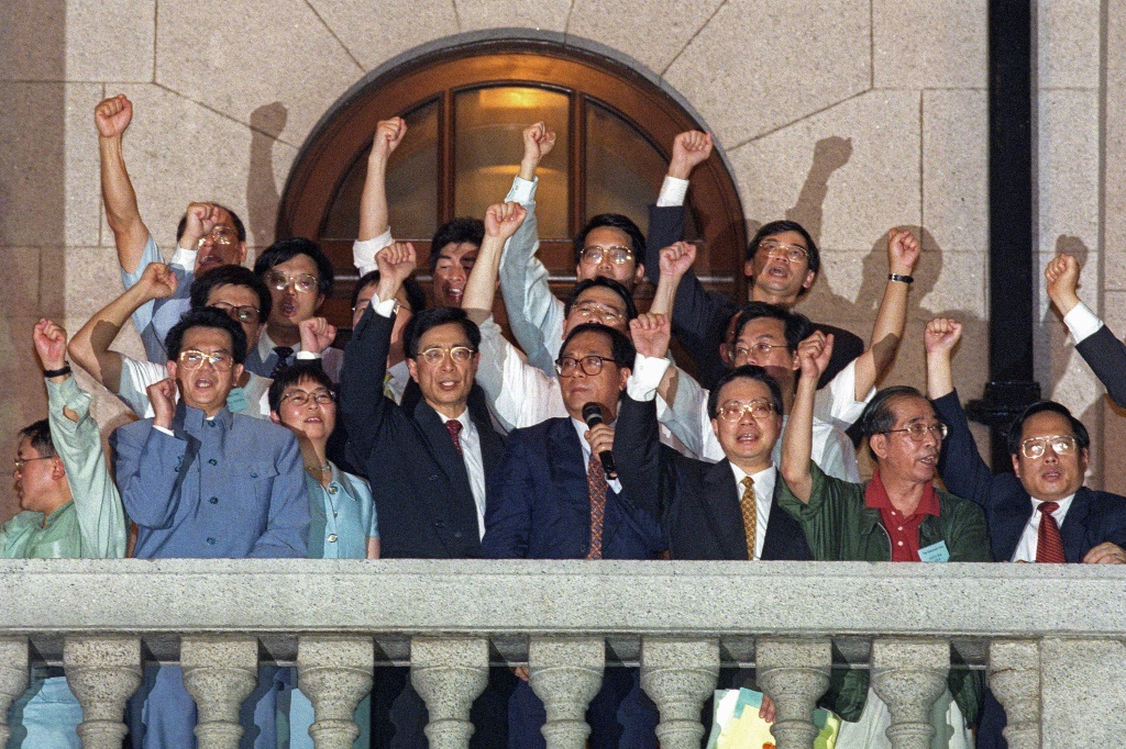 Pro-democracy politicians on the balcony of the city's legislature protest their unseating following Hong Kong's handover to China