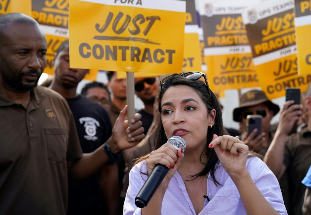 US Representative Alexandria Ocasio-Cortez, Democrat of New York, speaks to United Parcel Services (UPS) workers during a 'practice picket line' on July 7, 2023, in the Queens borough of New York City, ahead of a possible UPS strike