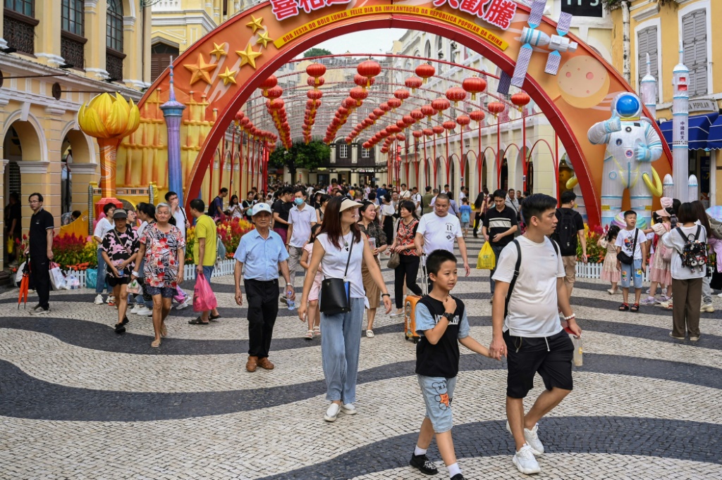 Chinese tourists walk through Senado Square in Macau